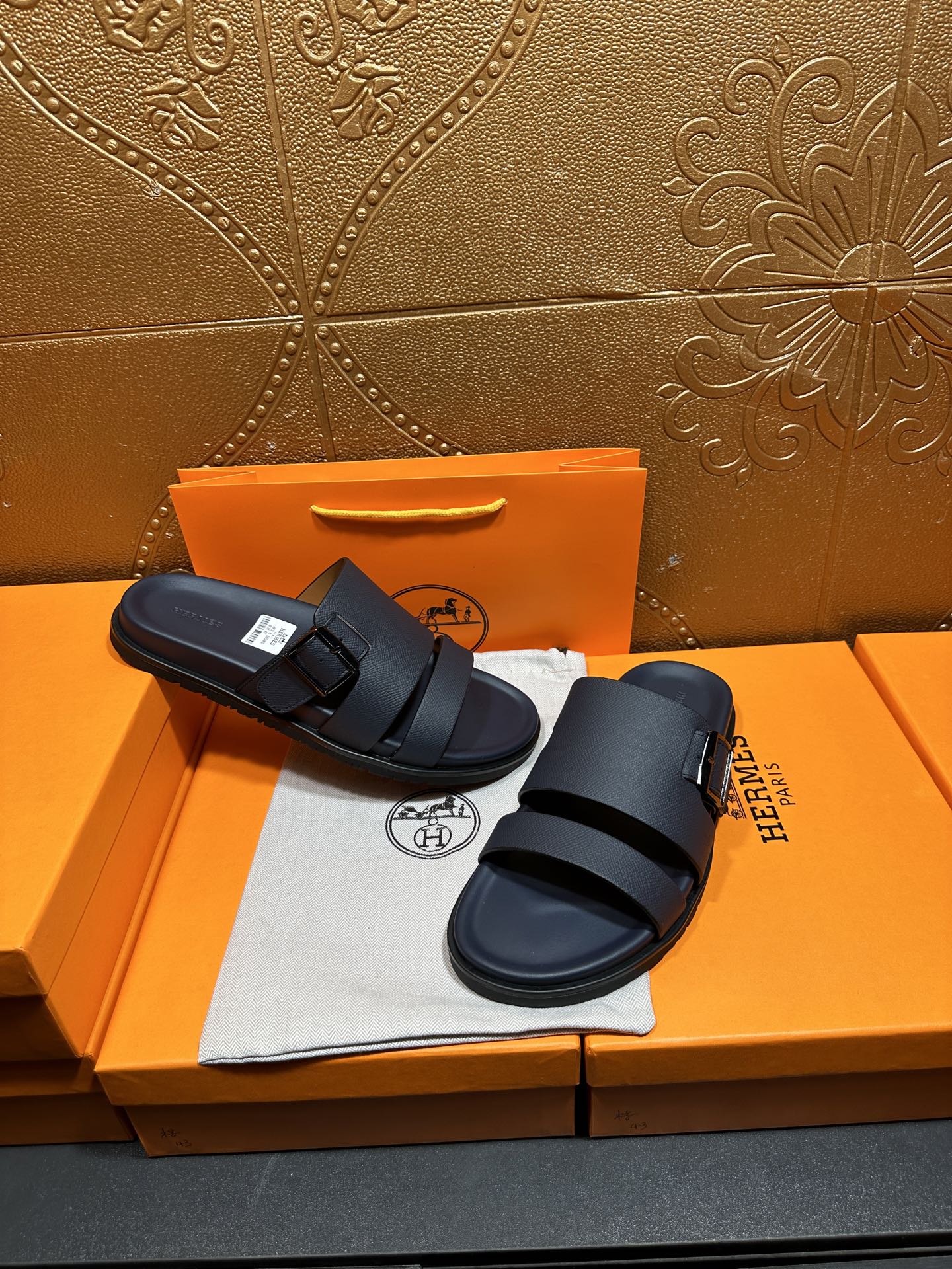 Blue slide sandals with two buckled straps, one sandal shifted slightly
