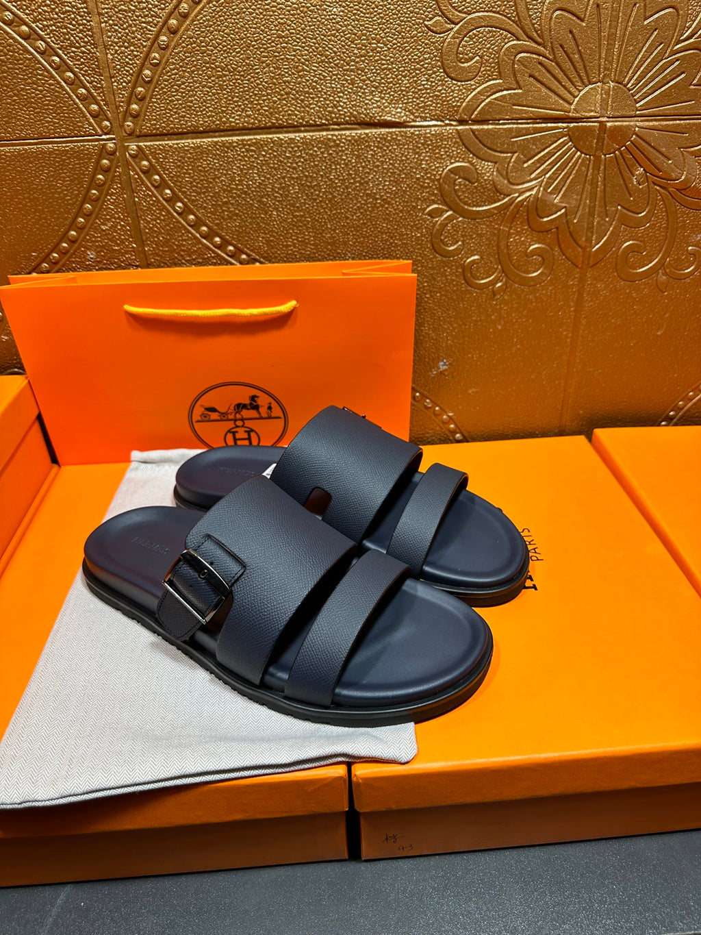 Blue slide sandals with two buckled straps, front and side view