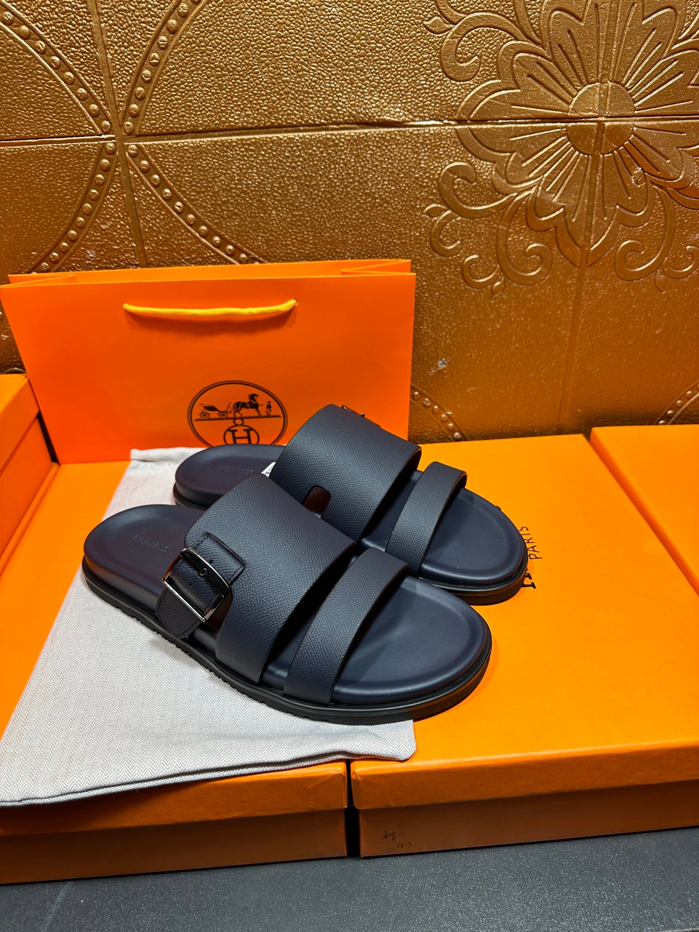 Blue slide sandals with two buckled straps, front and side view