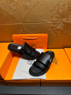 Hermes black slide sandals with double straps, top view on shoebox