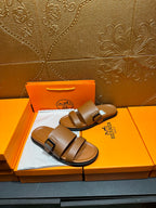 Hermes tan-brown slide sandals with wide straps and adjustable buckle