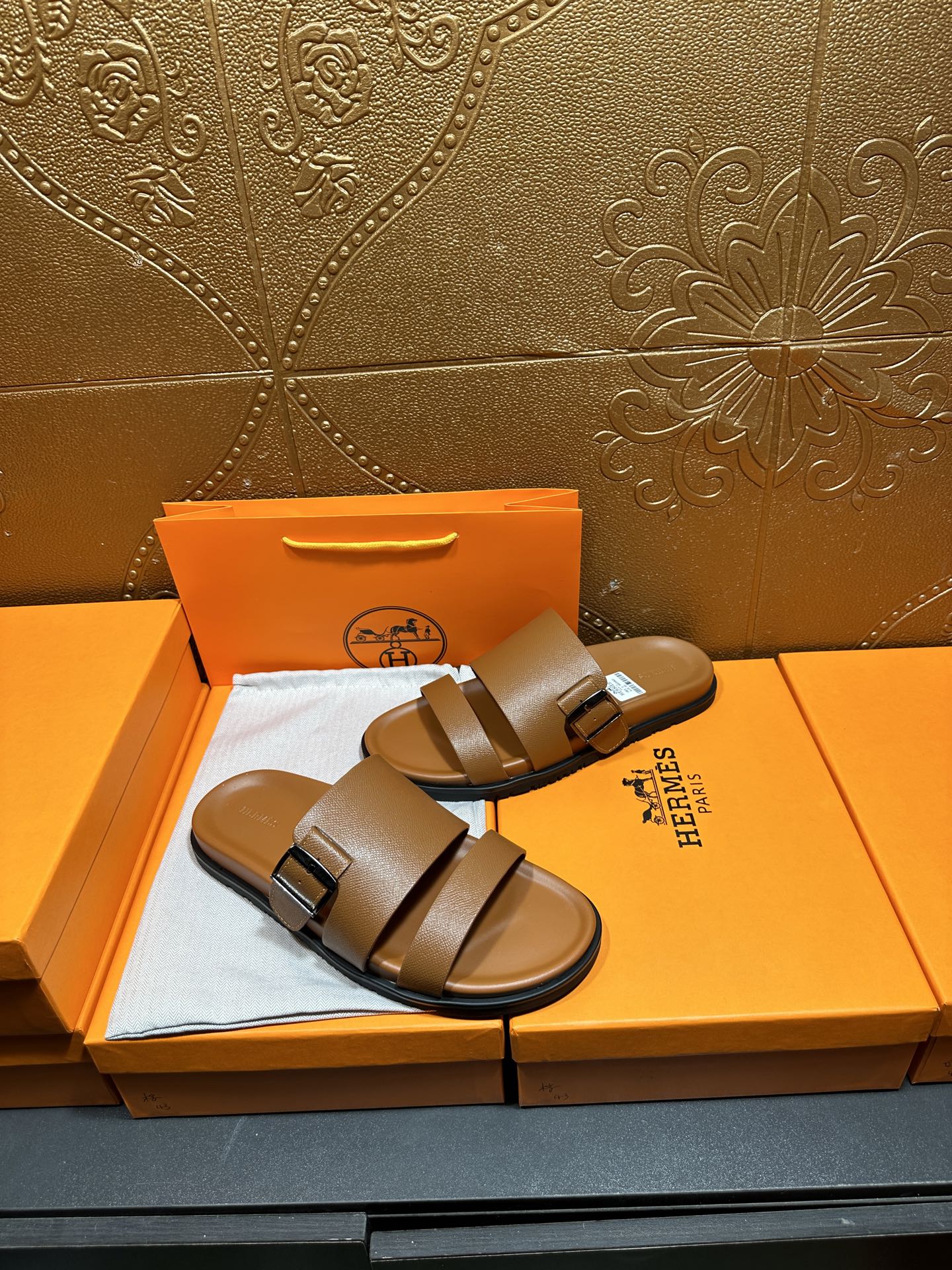 Hermes tan-brown slide sandals with wide straps and adjustable buckle
