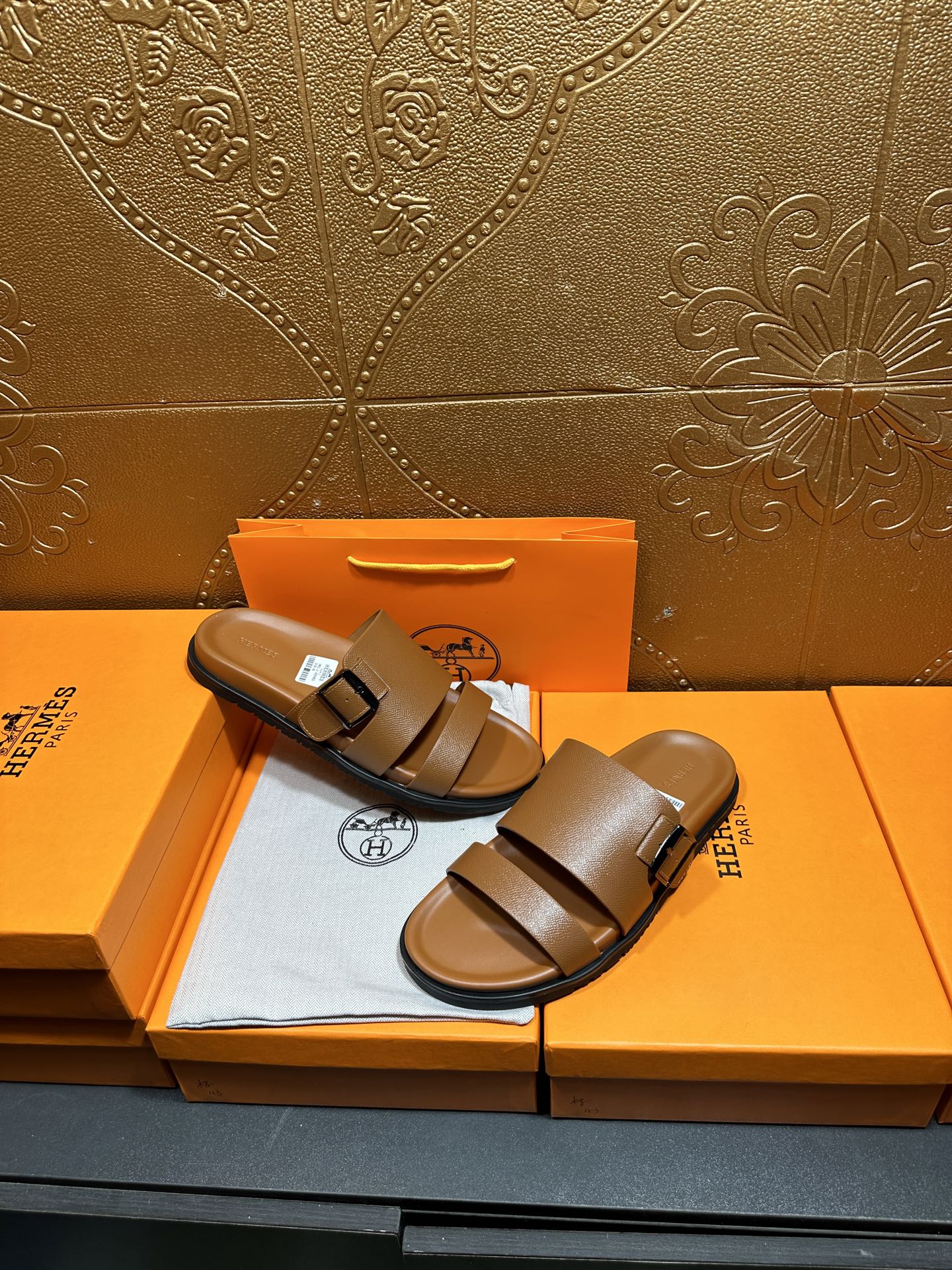 Hermes tan-brown leather sandals with two wide straps and adjustable metal buckle