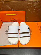 Hermes white leather sandals with two straps and silver buckle, front view