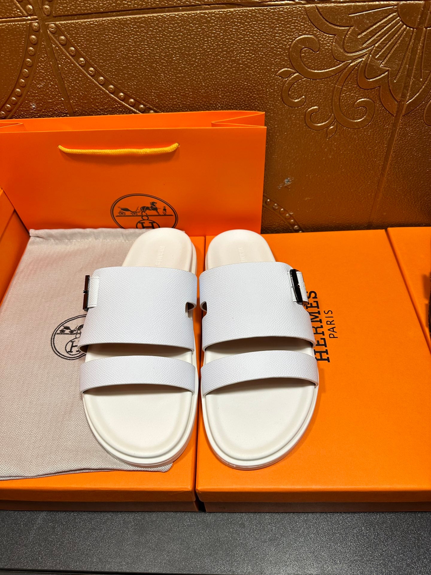 Hermes white leather sandals with two straps and silver buckle, front view