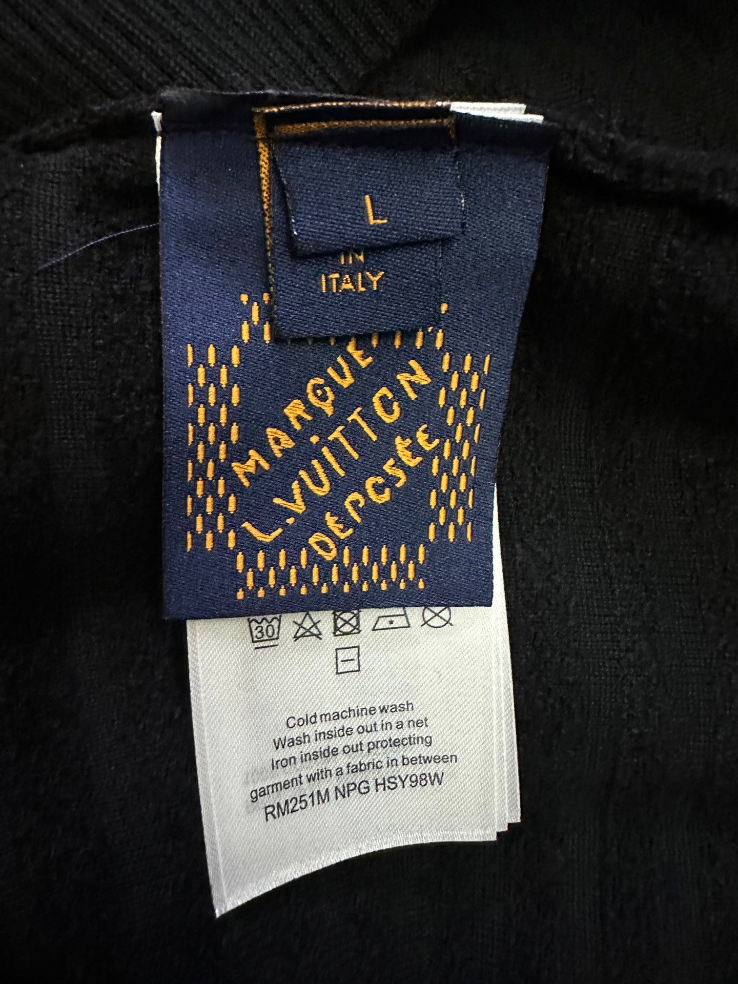 Louis Vuitton clothing care label and size tag with washing instructions