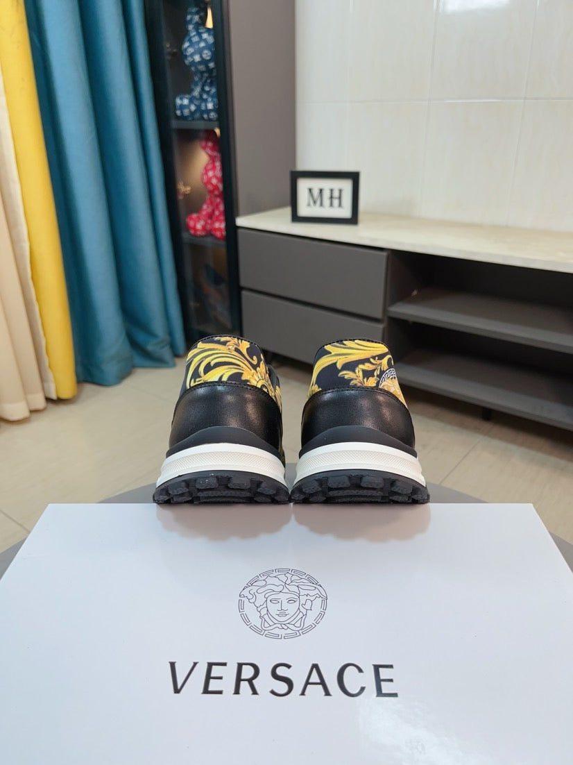 Versace sneakers, black uppers with gold and yellow baroque accents, white soles