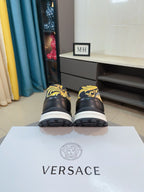 Versace sneakers, black uppers with gold and yellow baroque accents, white soles
