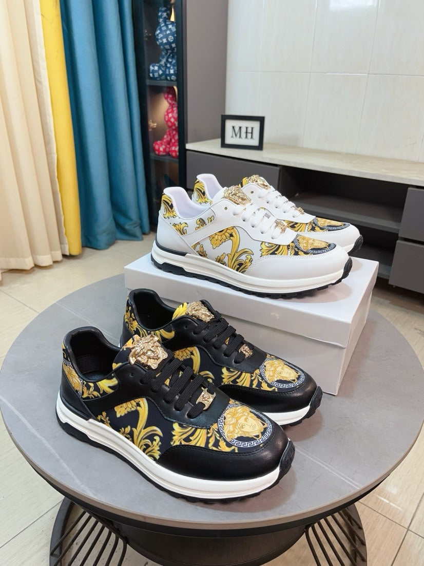 Black and gold printed sneakers with lace-up front and chunky white rubber sole