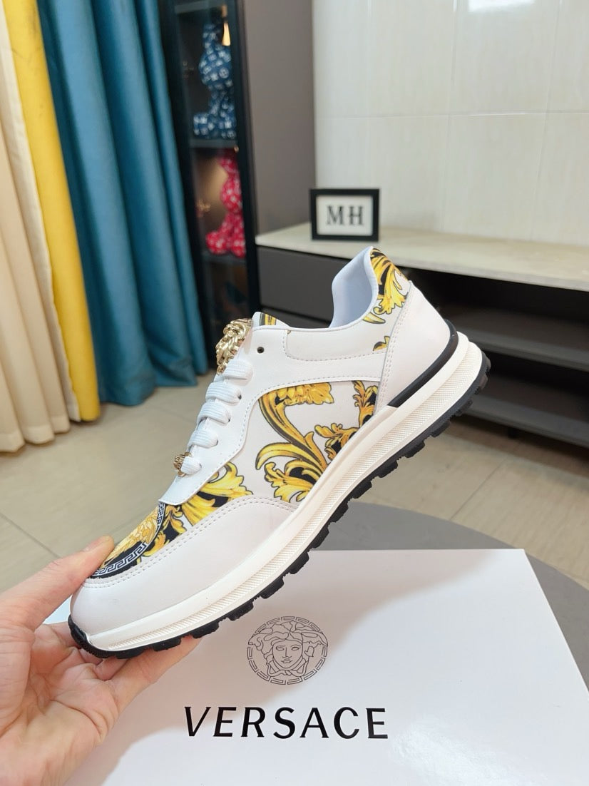 White lace-up sneakers with gold baroque-style panel print and thick rubber sole