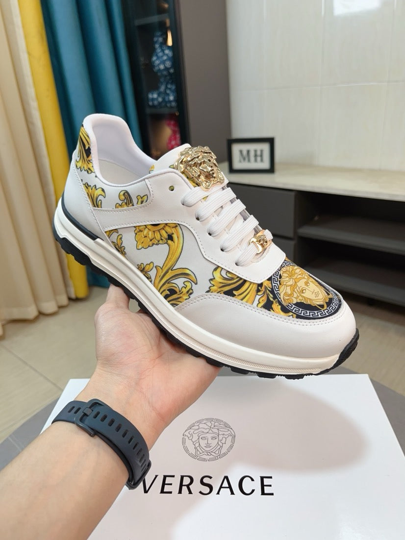 White lace-up sneakers with gold decorative print and textured gold heel accent