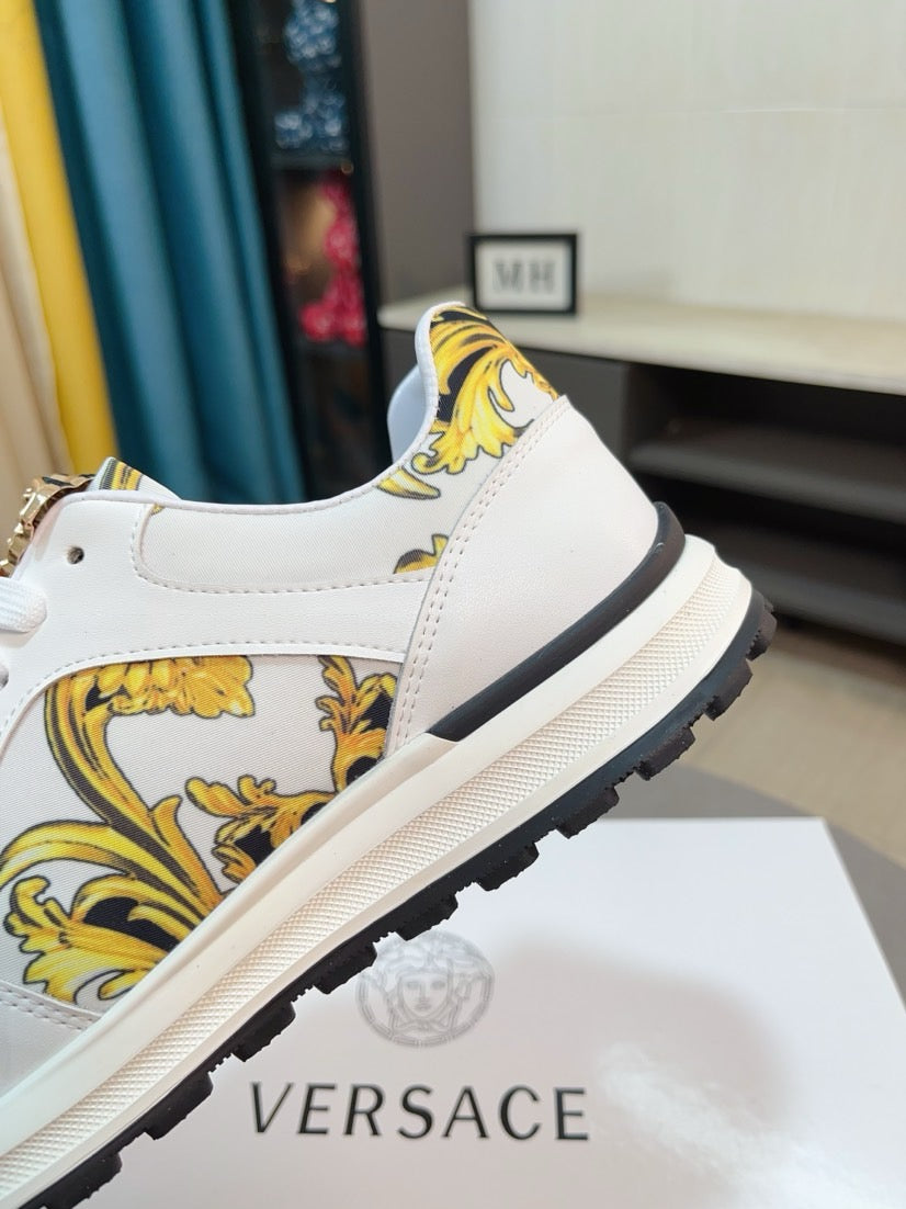 Dark rubber sneaker outsole with raised tread and small gold logo detail