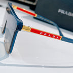 Prada sunglasses side view with blue frame and red PRADA logo detail