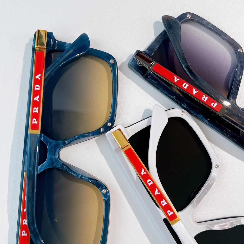 Prada sunglasses pair with blue frame and gold lens, plus white frame with black lens