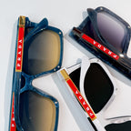 Prada sunglasses pair with blue frame and gold lens, plus white frame with black lens