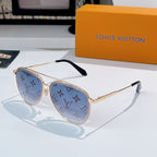 Louis Vuitton sunglasses with gold frame, blue tinted lenses, and monogram pattern temples