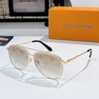 Louis Vuitton sunglasses with gold frame, light tinted lenses, and monogram pattern