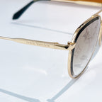 Louis Vuitton sunglasses side view with gold frame, monogram lens, and black temple tips
