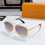 Louis Vuitton sunglasses with gold frame, amber tinted lenses, and monogram pattern