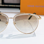 Louis Vuitton round sunglasses with gold frame and monogram patterned lens detail