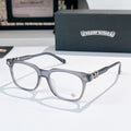 Chrome eyeglasses with dark frames, clear lenses, and star-like metal accents