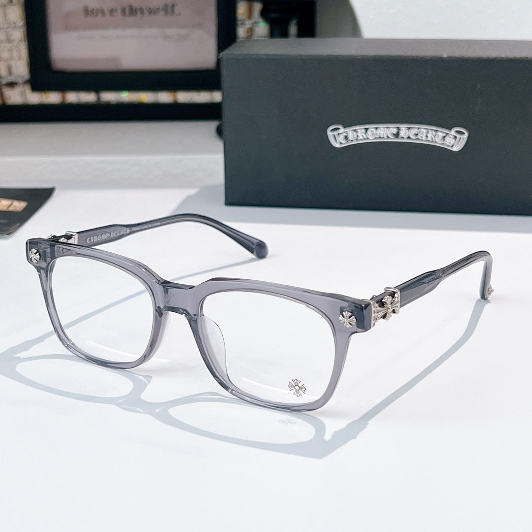 Chrome eyeglasses with dark frames, clear lenses, and star-like metal accents