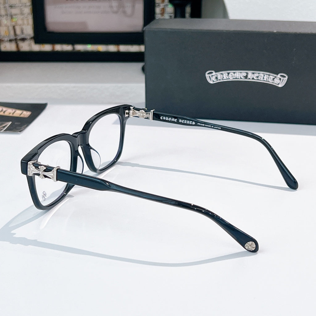 Chrome eyeglasses side view with dark frames and metal bridge detail, clear lenses