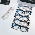 Chrome eyeglasses set with mixed frames and clear lenses, stacked on display