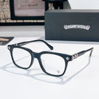 Chrome eyeglasses with dark frames, gold-toned cross detail at the hinge, clear lenses