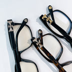 Chrome eyeglasses assortment with black frames, tortoise-pattern frames, and cross hinges