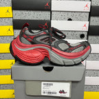Chunky low-top sneaker pair on box; black, gray, and red mesh upper
