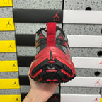 Sneaker heel view with red pull tab on black and gray upper