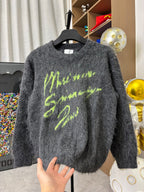 Dark gray fuzzy crewneck sweater with neon green graphic print, long sleeves
