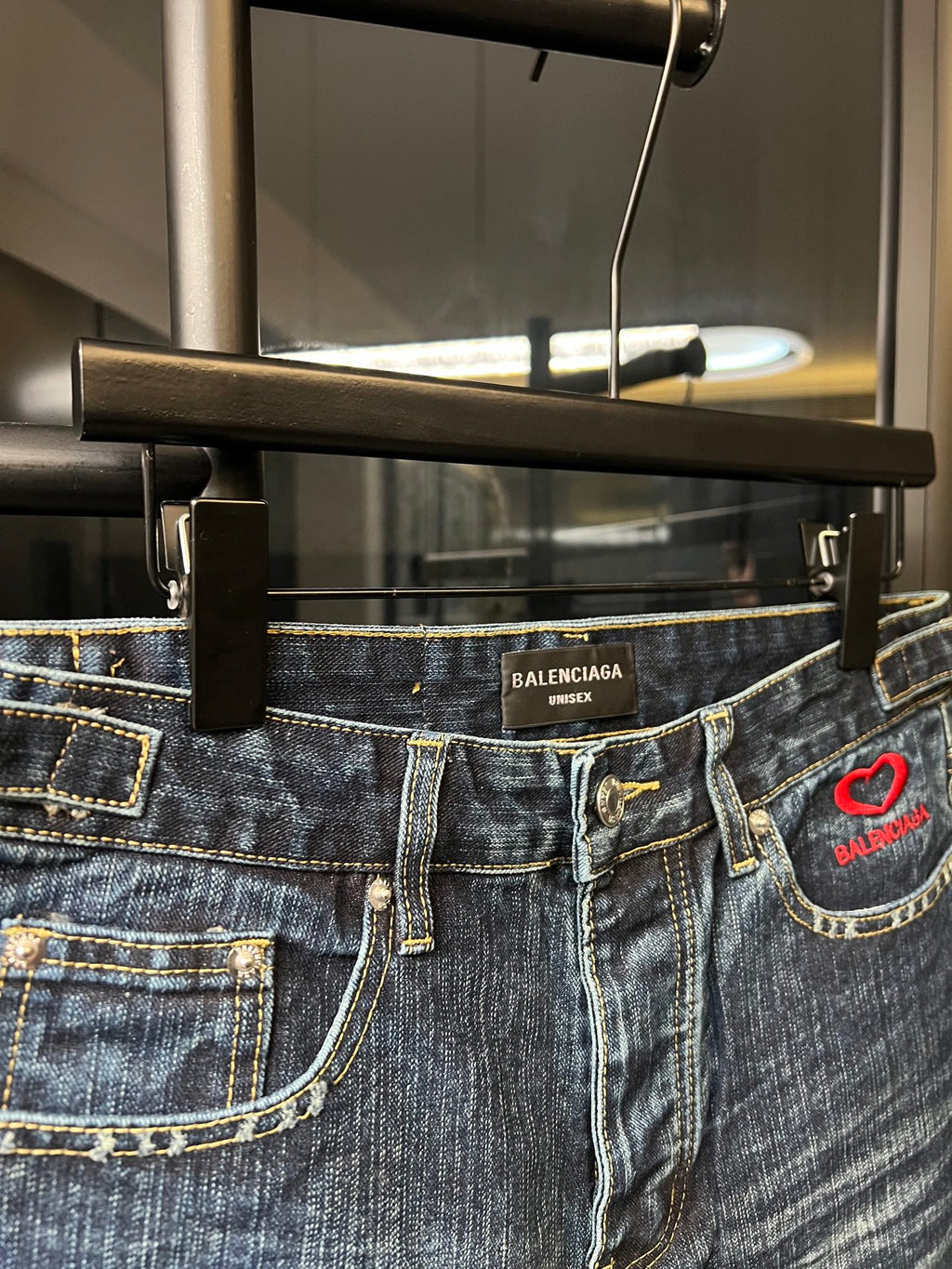 Balenciaga denim shorts waistband detail with belt loops and red heart logo patch