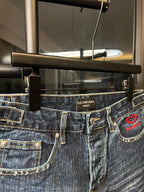 Balenciaga denim shorts waistband detail with belt loops and red heart logo patch