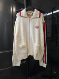 Gucci cream knit zip-up sweater with ribbed collar, red stripe on shoulder, GG patch