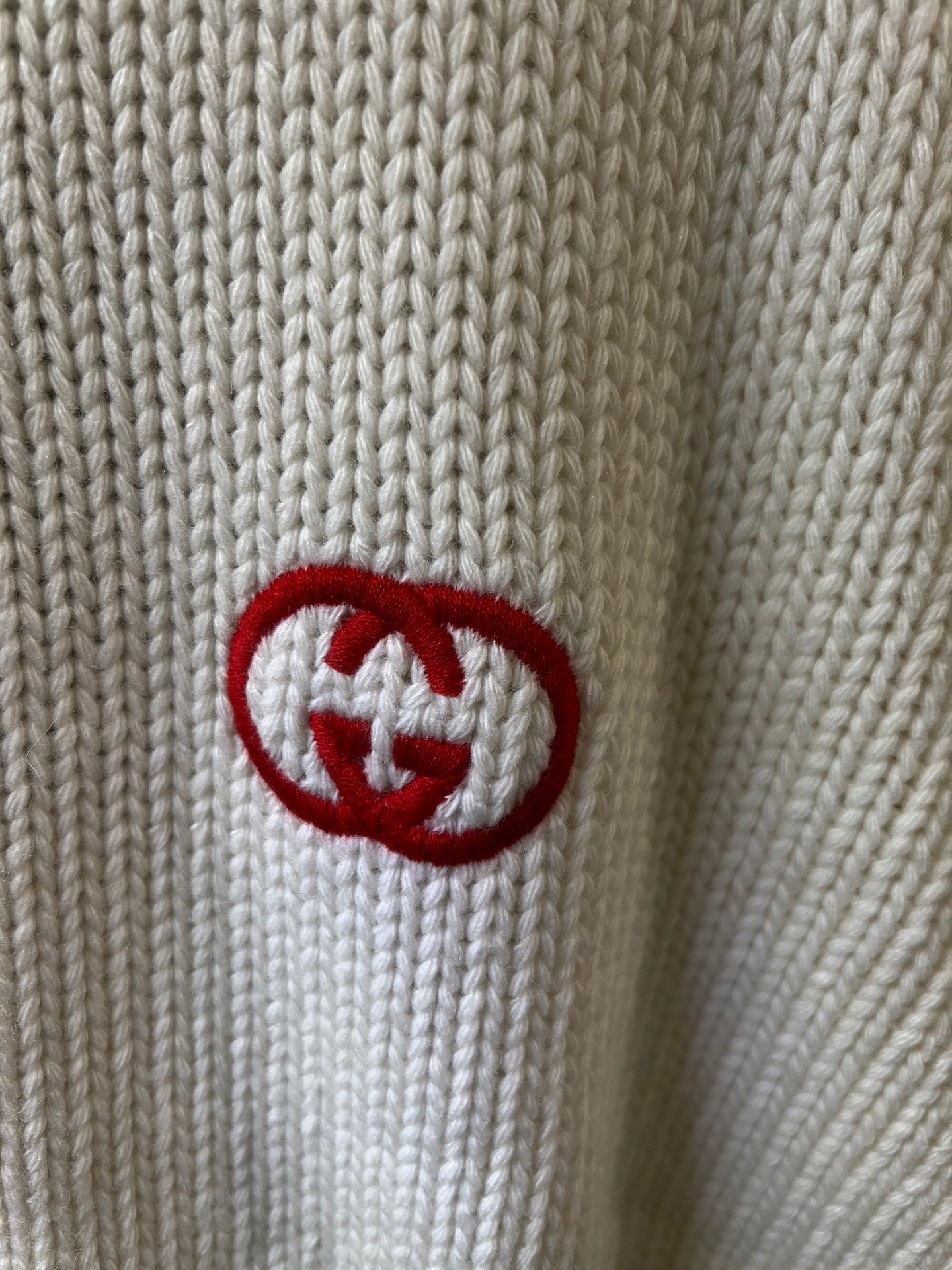 Gucci knit sweater detail with GG emblem patch in red and white