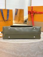 Olive green leather satchel bag with front flap and silver-tone feet