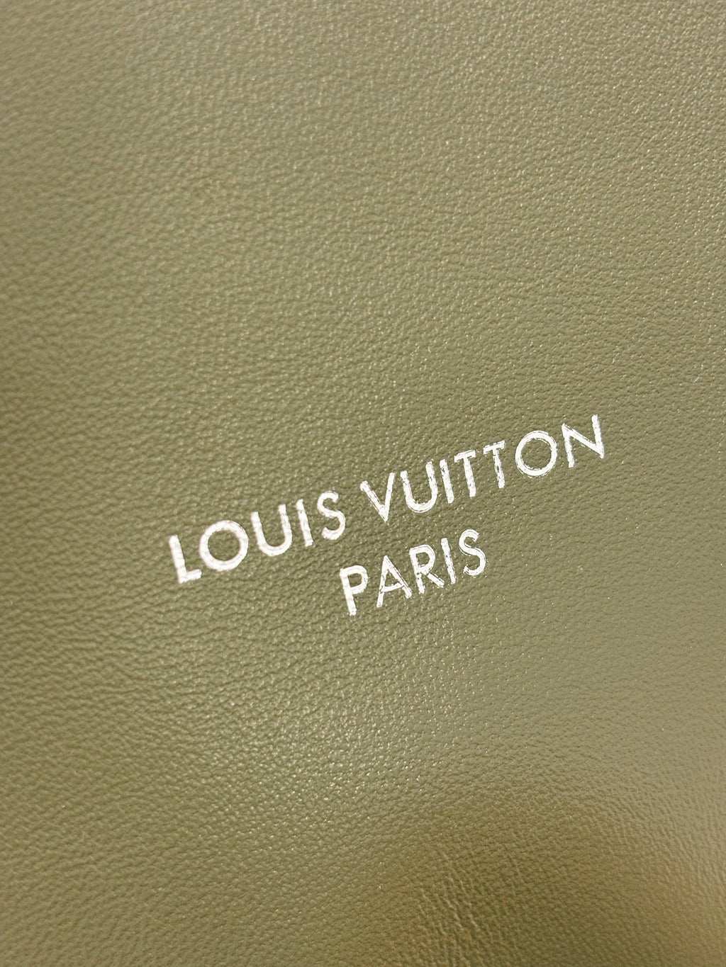 Louis Vuitton Paris logo on olive green leather bag panel