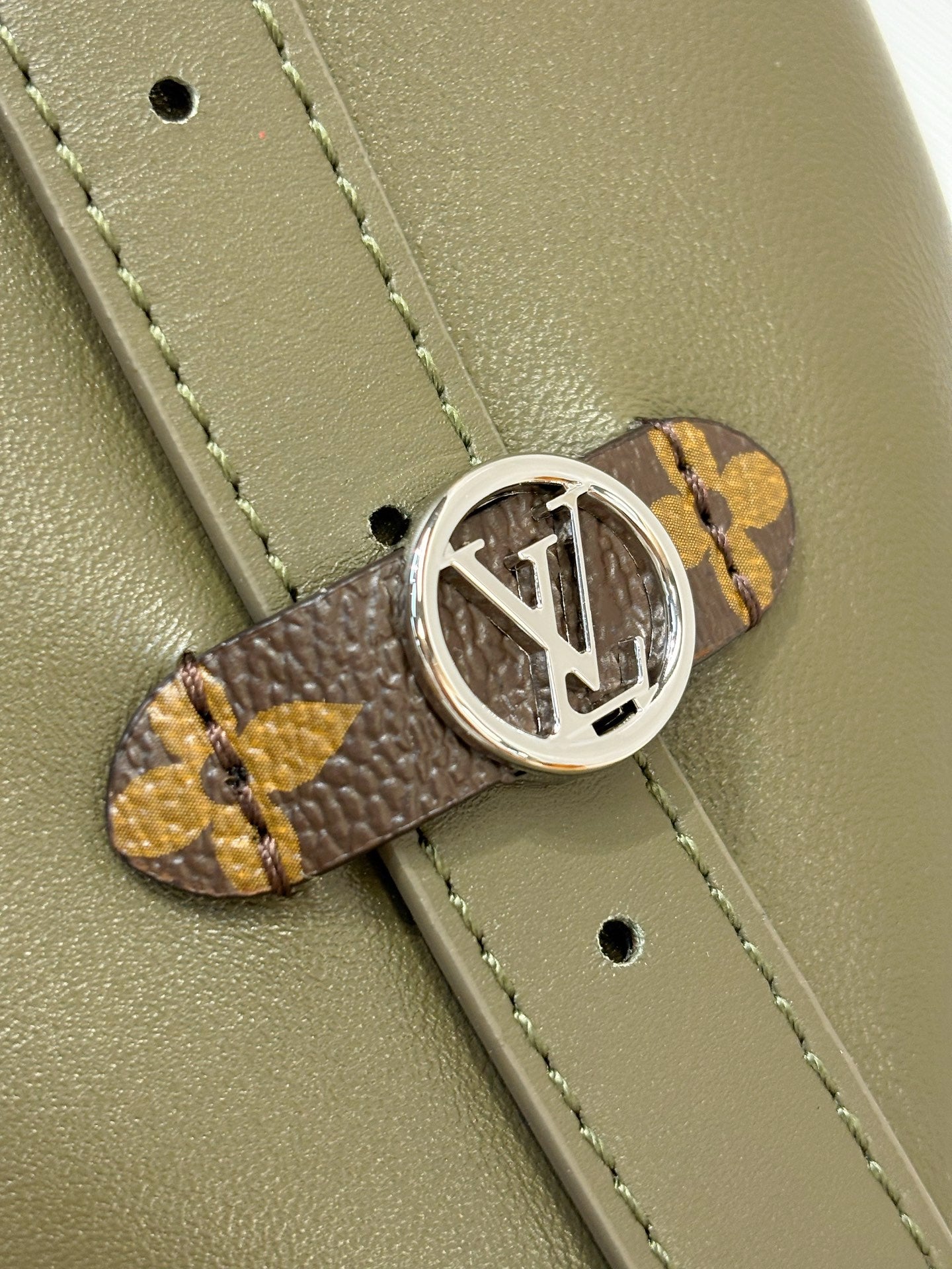 Olive green leather strap with Louis Vuitton monogram buckle clasp