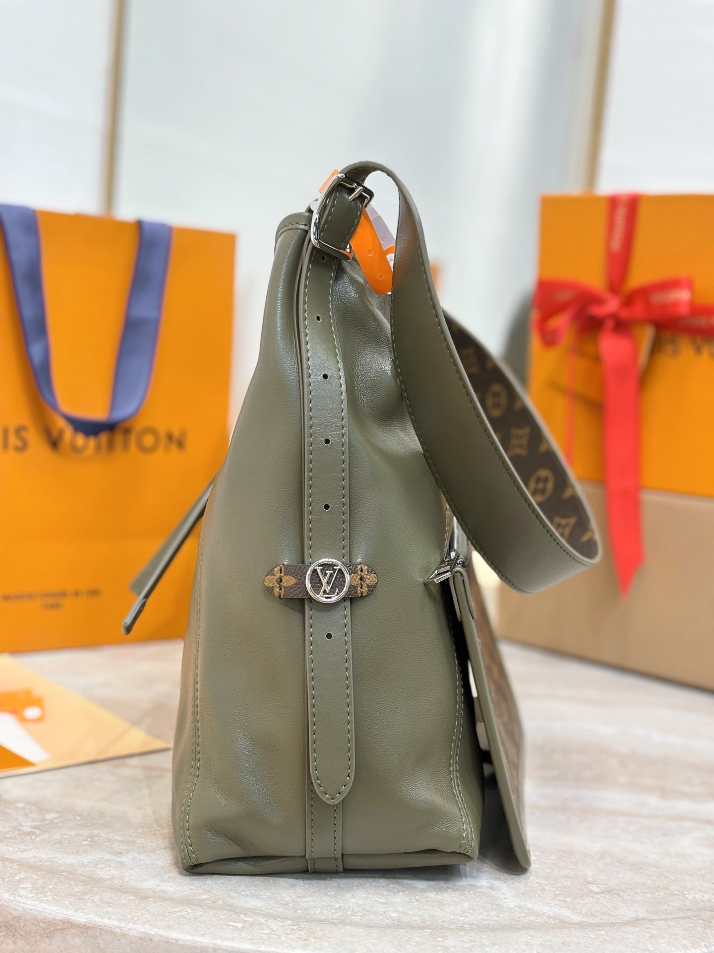 Olive green leather tote with adjustable strap and side hanging charm