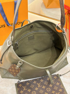 Olive green leather bag interior with zip pocket and monogram pouch