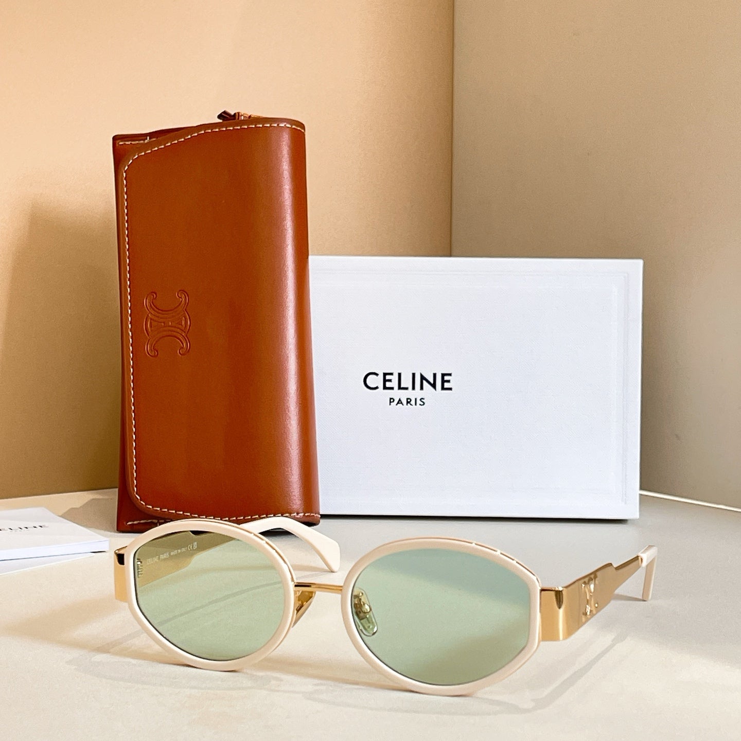 Celine glasses with white frames and pale green tinted lenses