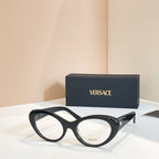 Round eyeglasses with dark frames and clear lenses, metal hinge and temple arms