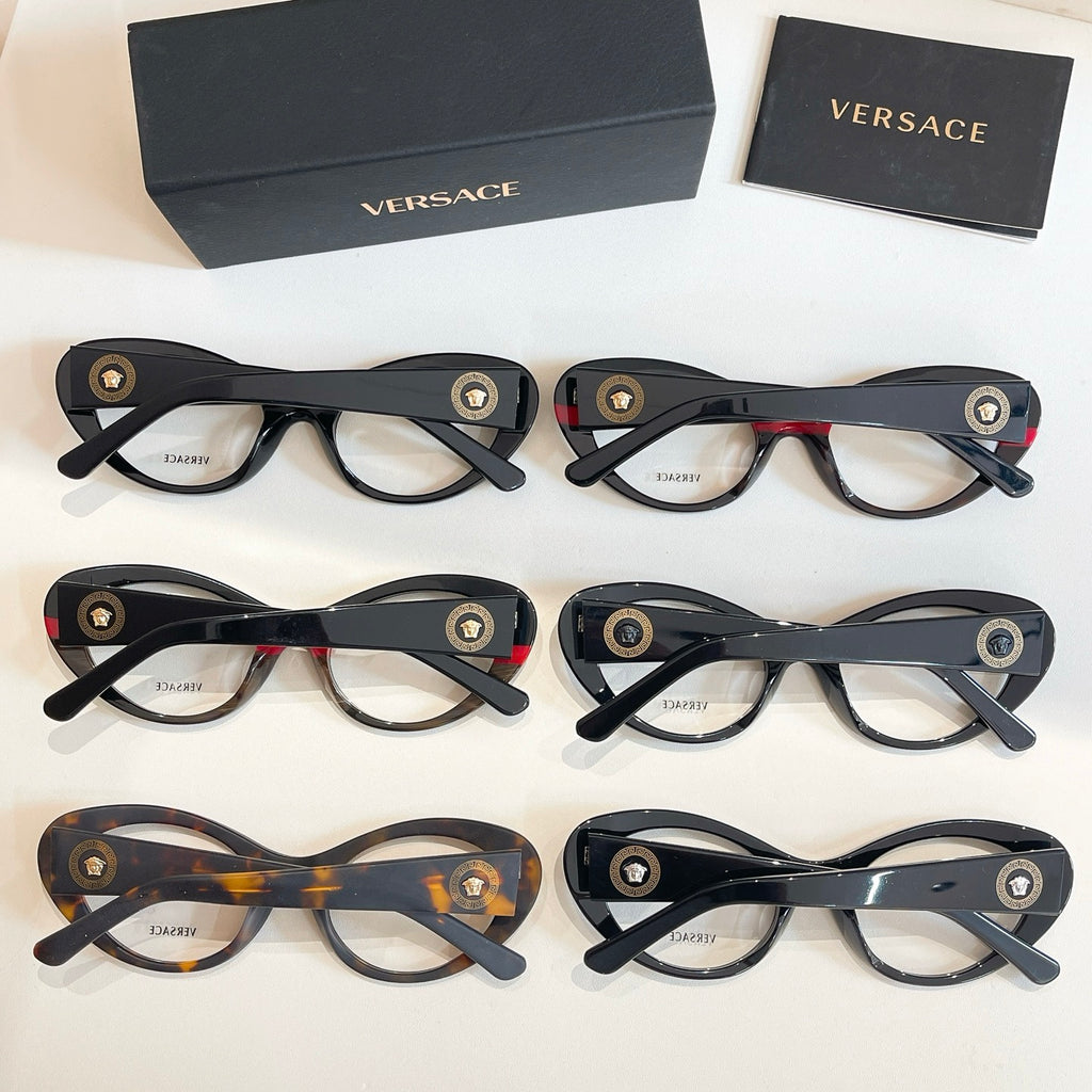 Set of round eyeglasses with clear lenses in dark, tortoiseshell, and red-accented frames