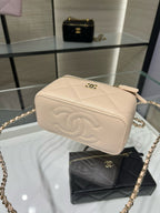 Chanel quilted mini bag, light beige, side view with embossed CC logo.