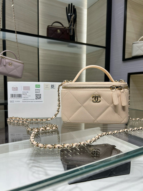 Chanel quilted handbag, light beige with top handle and chain strap.