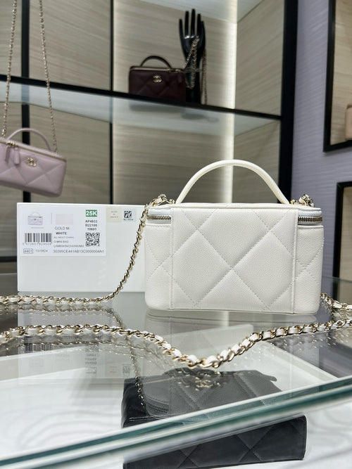 White quilted handbag with zipper top, gold chain shoulder strap, and CC logo.