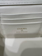 White handbag interior label reading CHANEL and MADE IN FRANCE.