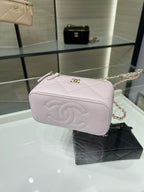 Chanel light pink quilted mini bag with gold CC clasp, top zip, and handle